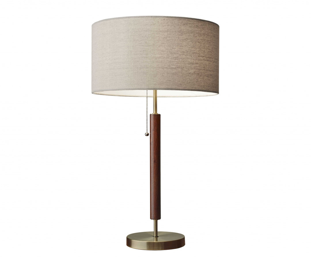 26" Antiqued Brass Solid Wood Table Lamp With Beige Drum Shade