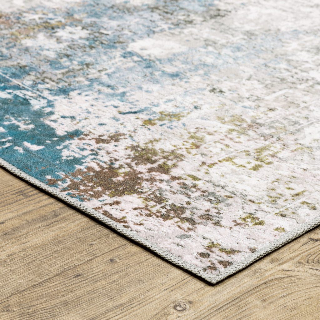 5' X 7' Ivory Teal Blue Grey Brown And Gold Abstract Printed Stain Resistant Non Skid Area Rug