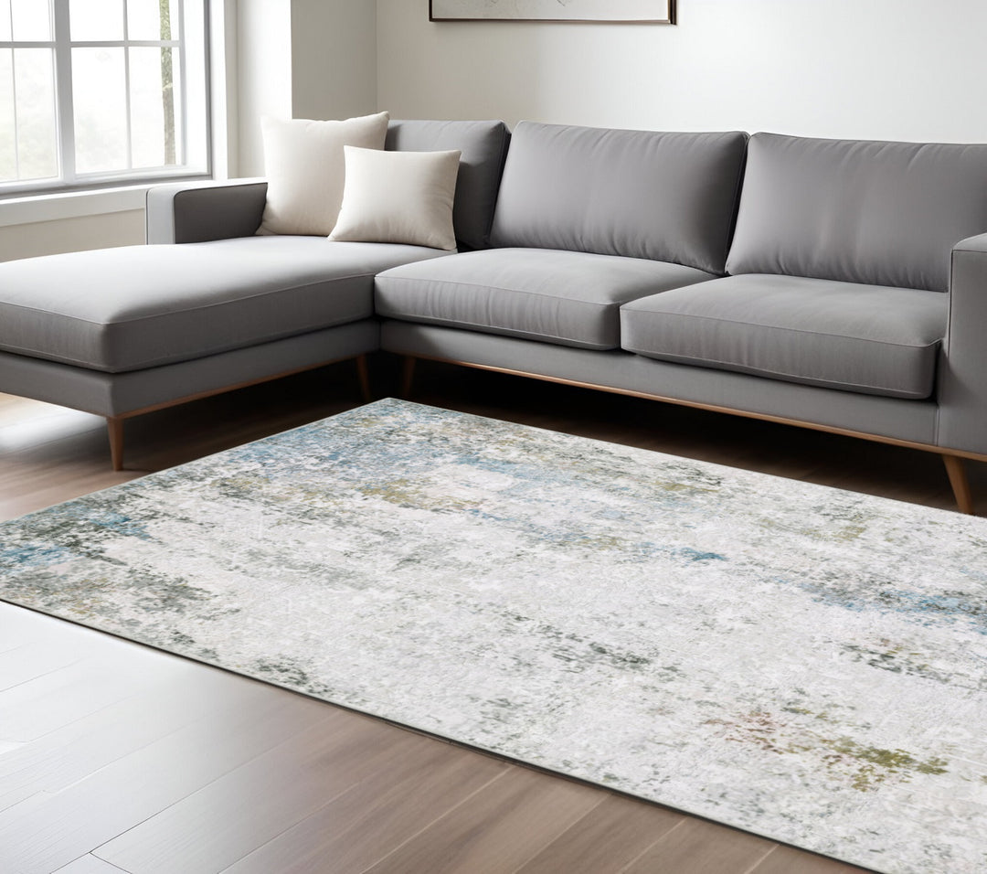 5' X 7' Ivory Teal Blue Grey Brown And Gold Abstract Printed Stain Resistant Non Skid Area Rug