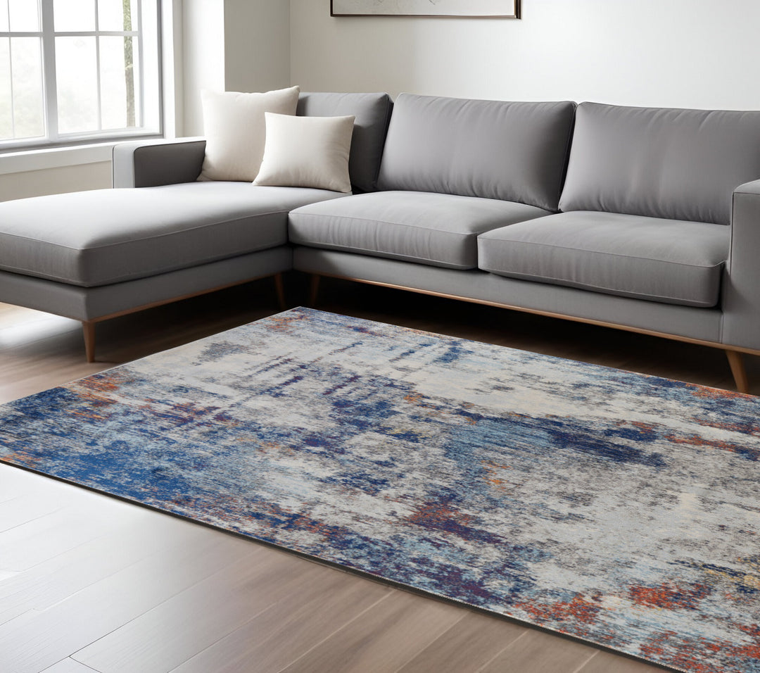 7' X 10' Ivory And Blue Abstract Power Loom Distressed Stain Resistant Area Rug