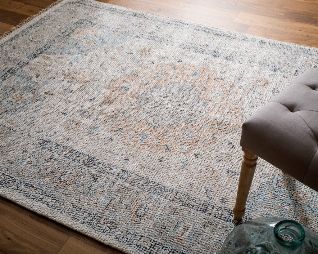 5' X 8' Ivory Blue and Orange Oriental Hand Woven Distressed Area Rug With Fringe