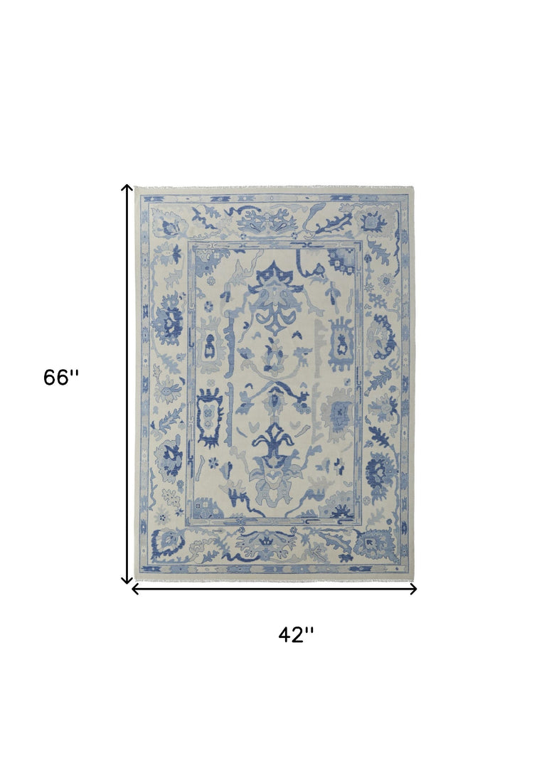 4' X 6' Ivory and Blue Wool Floral Hand Knotted Area Rug With Fringe