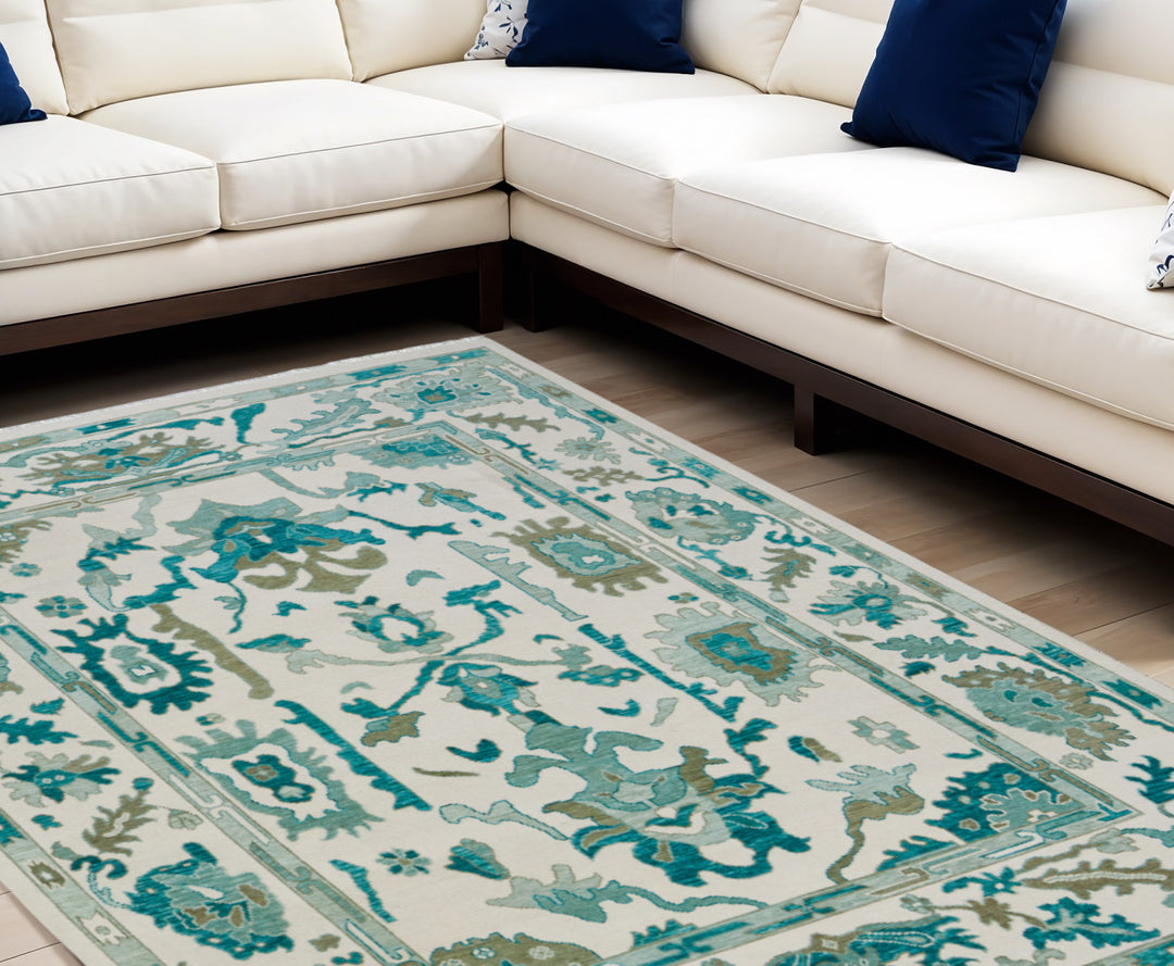 4' X 6' Ivory and Blue Wool Floral Hand Knotted Area Rug With Fringe