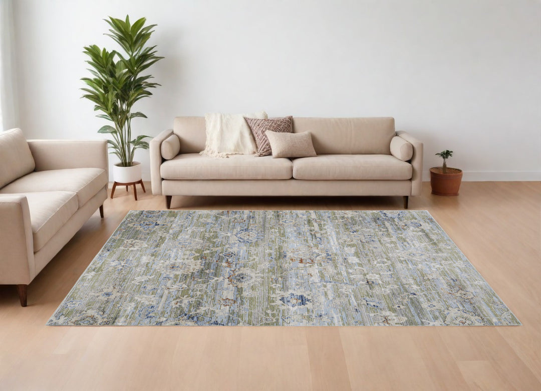 5' X 8' Ivory Green and Blue Floral Power Loom Worn Faded Area Rug