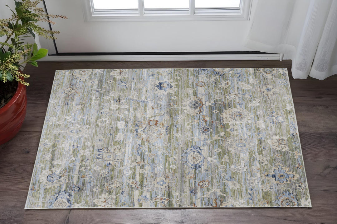 5' X 8' Ivory Green and Blue Floral Power Loom Worn Faded Area Rug